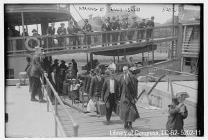 Photograph of immigrants arriving to Ellis Island, circa 1915