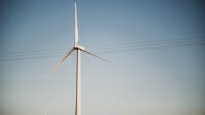 Lone wind turbine with blue sky