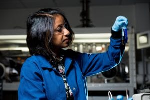 Female scientist holding two test tubes