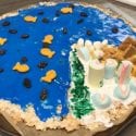 Lower elementary students decorate a cookie to represent Earth's physical geography