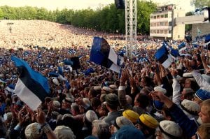 Large crowd in Estonia waving flags