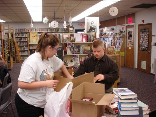 Student volunteers packing books