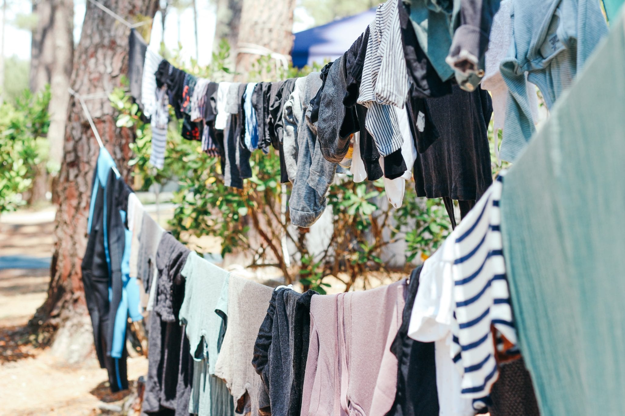 Clothes drying outdoors on clothesline tied to trees