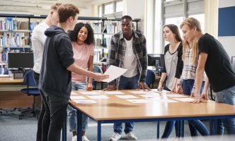 Secondary students plan work in a cooperative learning groups to complete a project