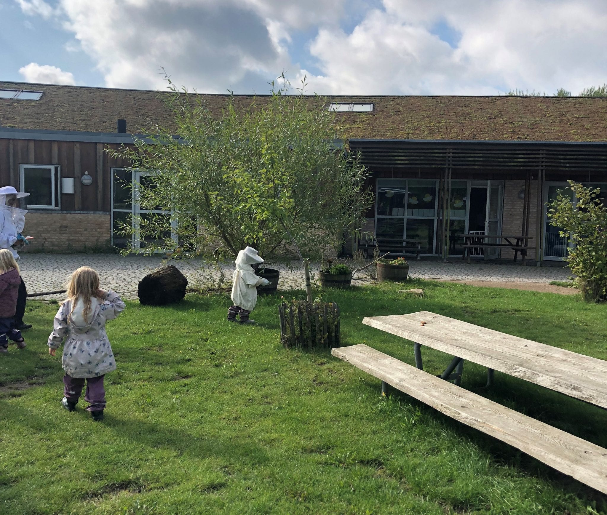 Slagelse, Denmark - Kindergarten children play outdoors and tend to beehives at Skovbørnehuset