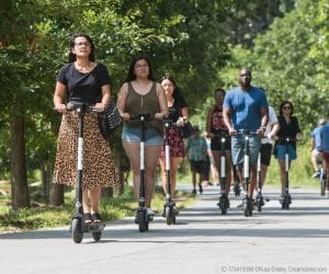 People ride e-scooters, a new means of transportation in the United States today