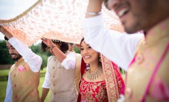 Indian bride being taken to the altar by her brothers