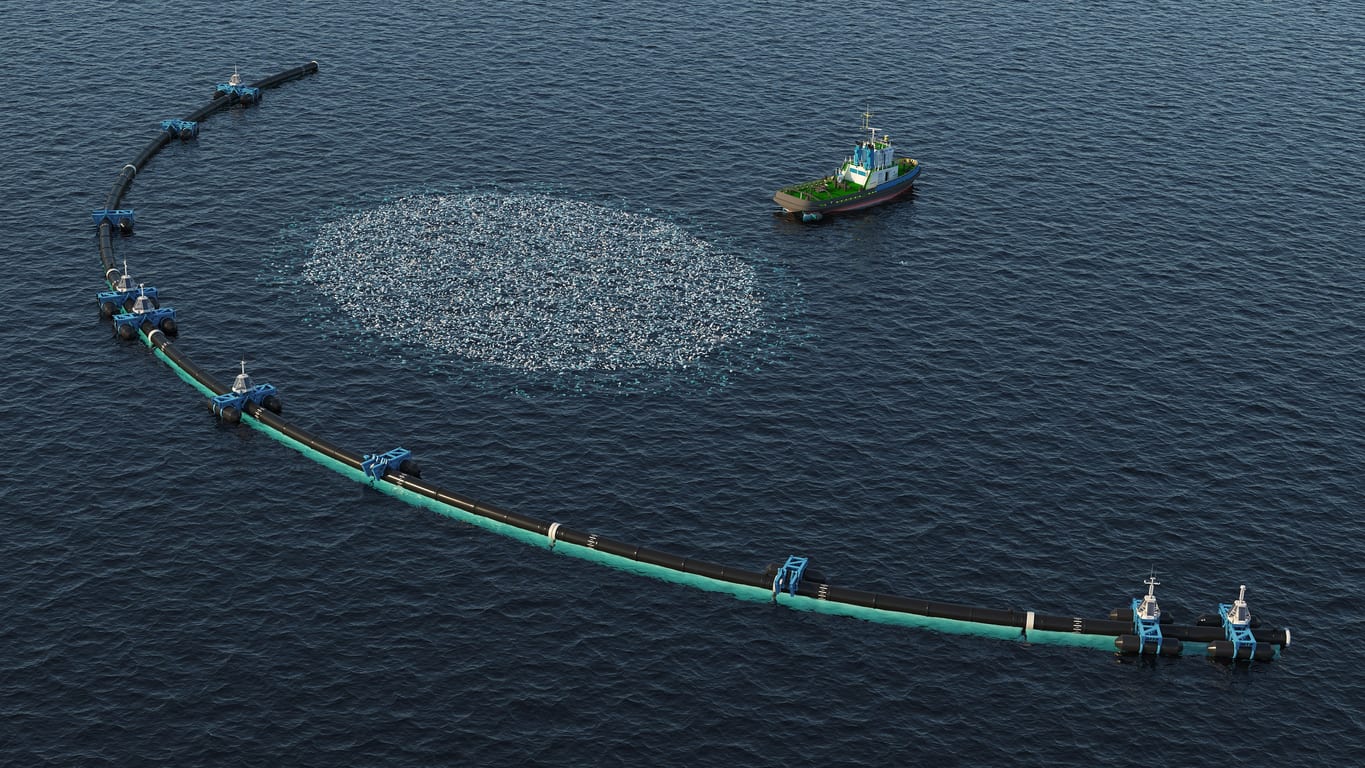 Aerial view of ocean boom and boat floating in water