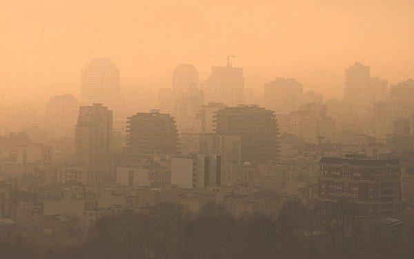 An orange haze covers Tehran's city skyline, due to air pollution in the region