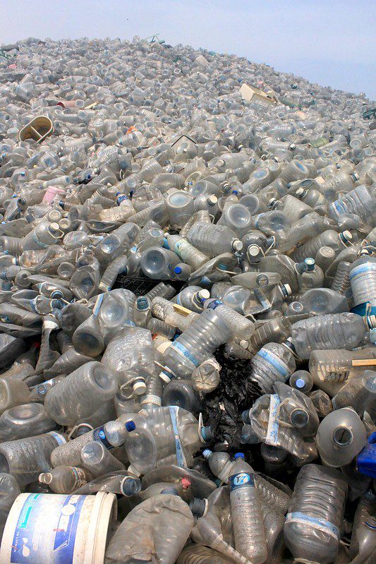 Mountainous pile of dirt-covered plastic bottles