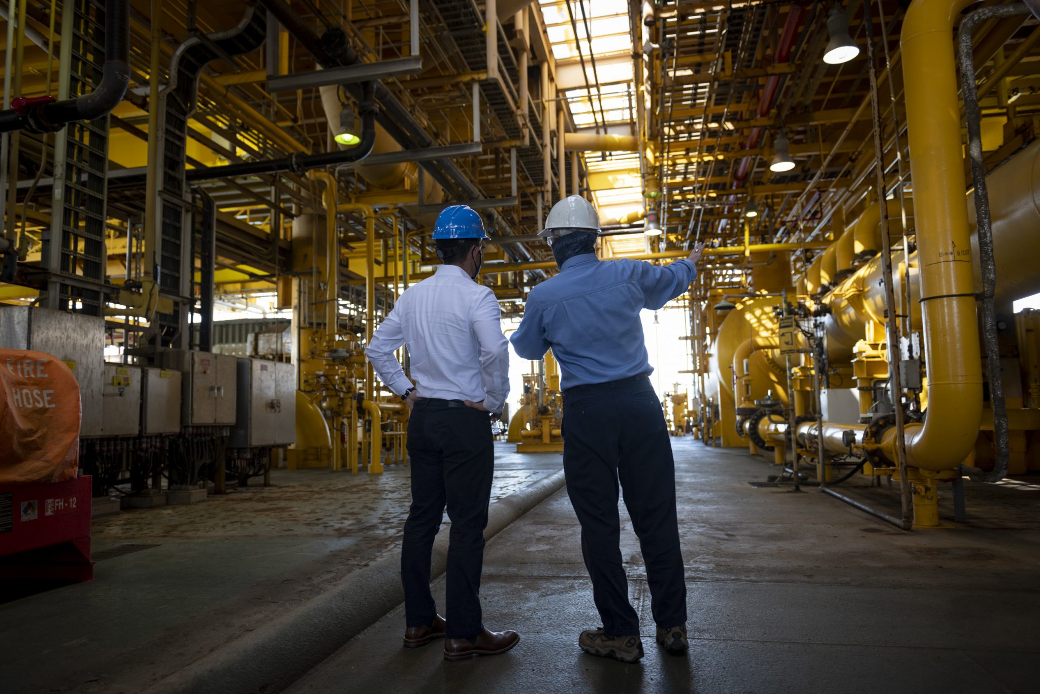 Men surveying a waste facility