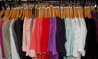 Rack of fast fashion t-shirts at a clothing store