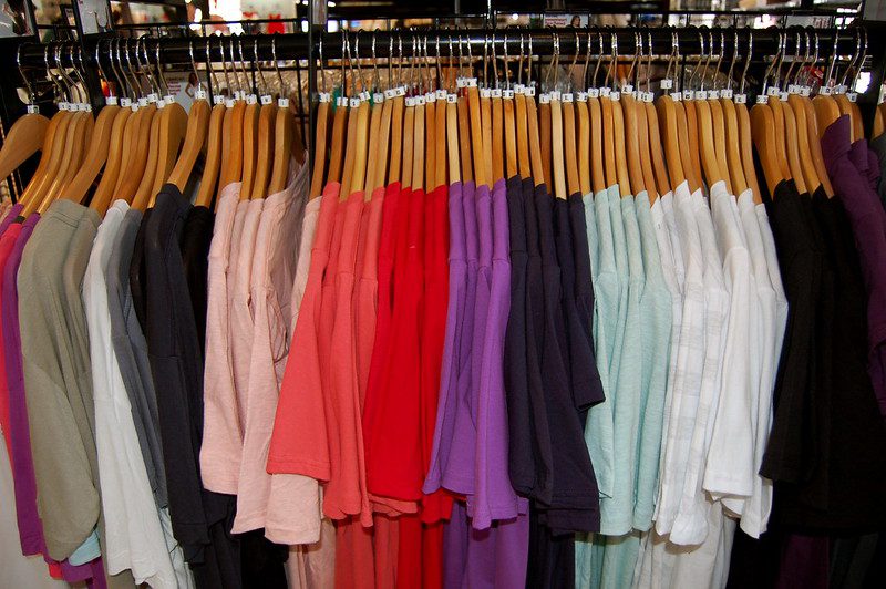 Rack of fast fashion t-shirts at a clothing store