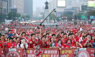Crowd of Korean soccer fans wearing red