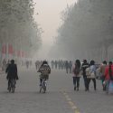 People walk and bike through severe air pollution in Anyang, China.