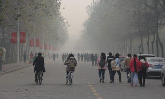 People walk and bike through severe air pollution in Anyang, China.