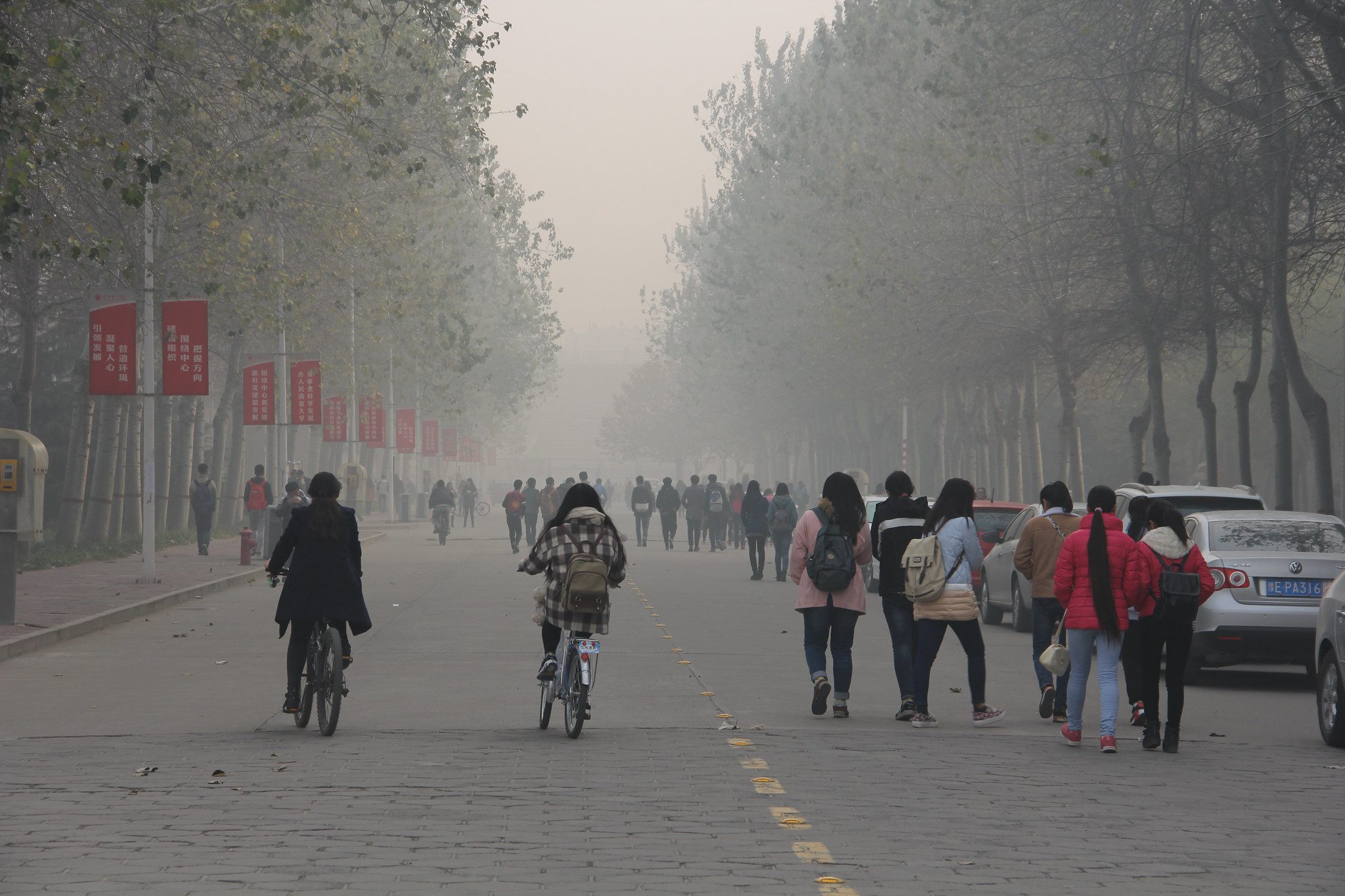 People walk and bike through severe air pollution in Anyang, China.