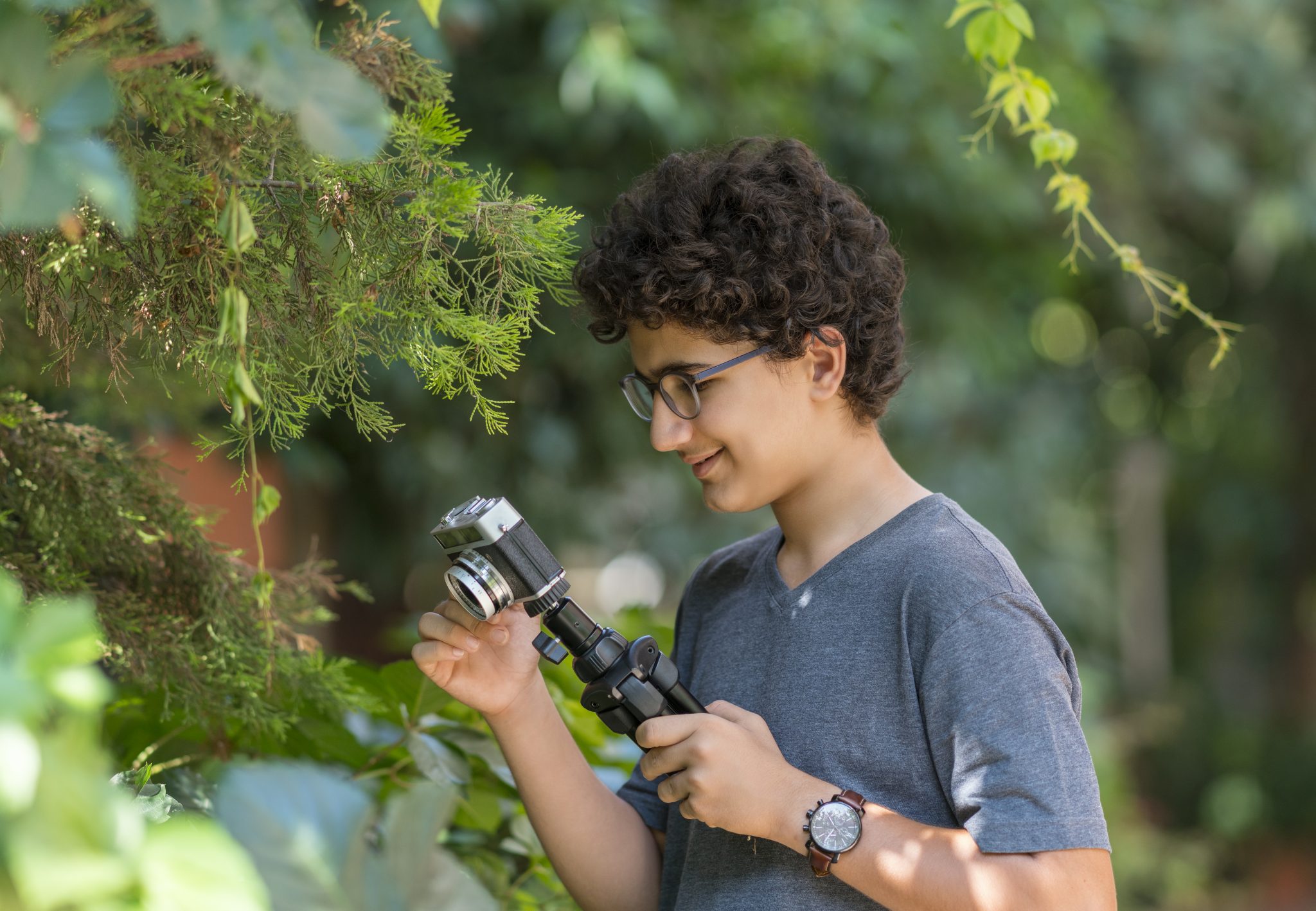 Teenage boy taking pictures outdoors