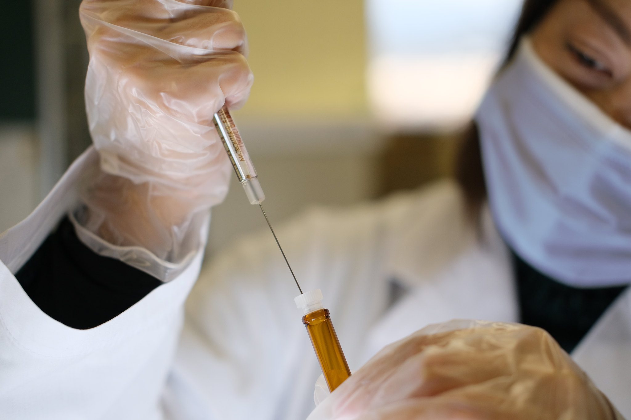 Doctor holding syringe and vial.