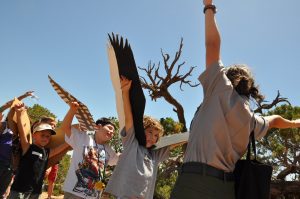 A park ranger leads elementary students during Camp Raptor Week