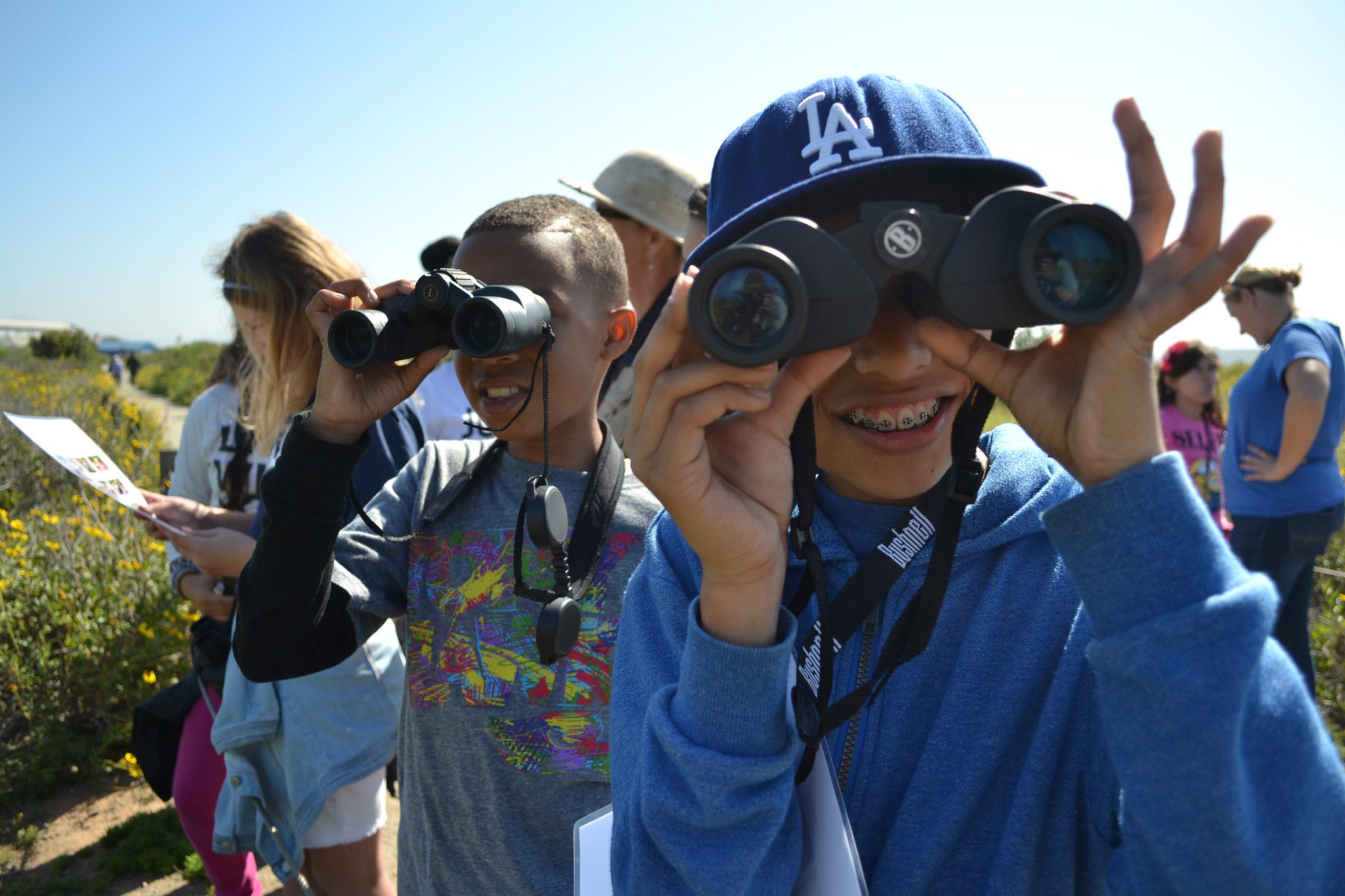 Elementary students playing a birding game on an environmental field trip.