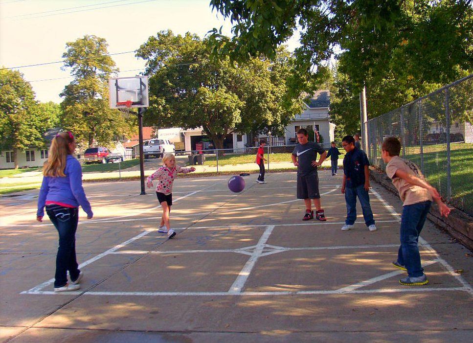 Playing four square during outdoor recess