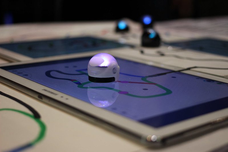 An Ozobot Evo robot follows a pre-programmed path on a tablet