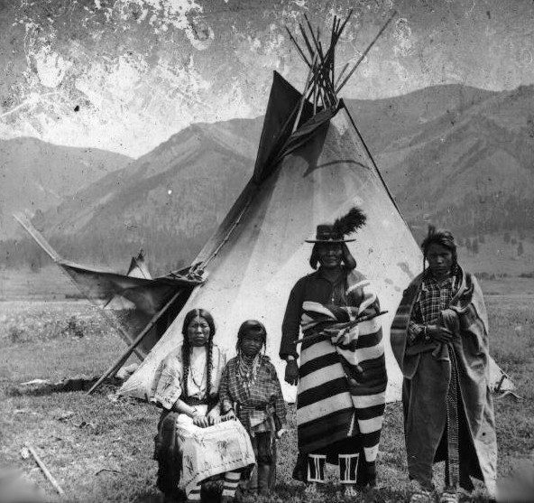 Family from the Flathead Nation poses in front of a tipi.