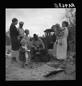 A family of Dust Bowl refugees gather on the highway near Bakersfield, California in 1935.