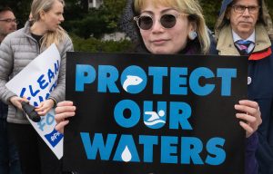 A protester outside the Supreme Court during the Sackett v. EPA hearing, which stripped federal protections from over half of the remaining wetlands in the United States.