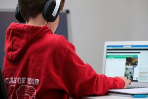 Young boy on a computer learning about media literacy.