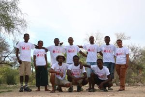 Ten people on the Lemur Love team pose for a photo in matching t-shirts in Madagascar.