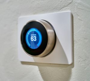 A smart home thermostat display shows the heat set to 63 degrees.