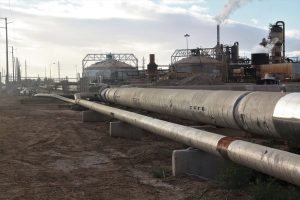 Large piping at a geothermal energy plant, which has a lower environmental impact than fossil fuels.