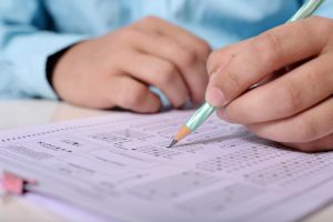 A close-up of a student filling in scantron bubbles.