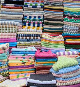 Piles of colorful clothing, folded into neat stacks.