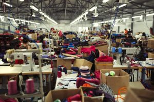 Cluttered workstations inside a garment factory
