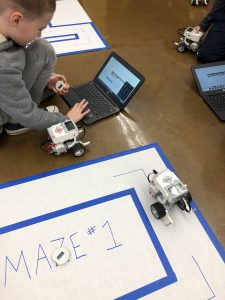 A middle school student programs a robot during an afterschool Robotics club.